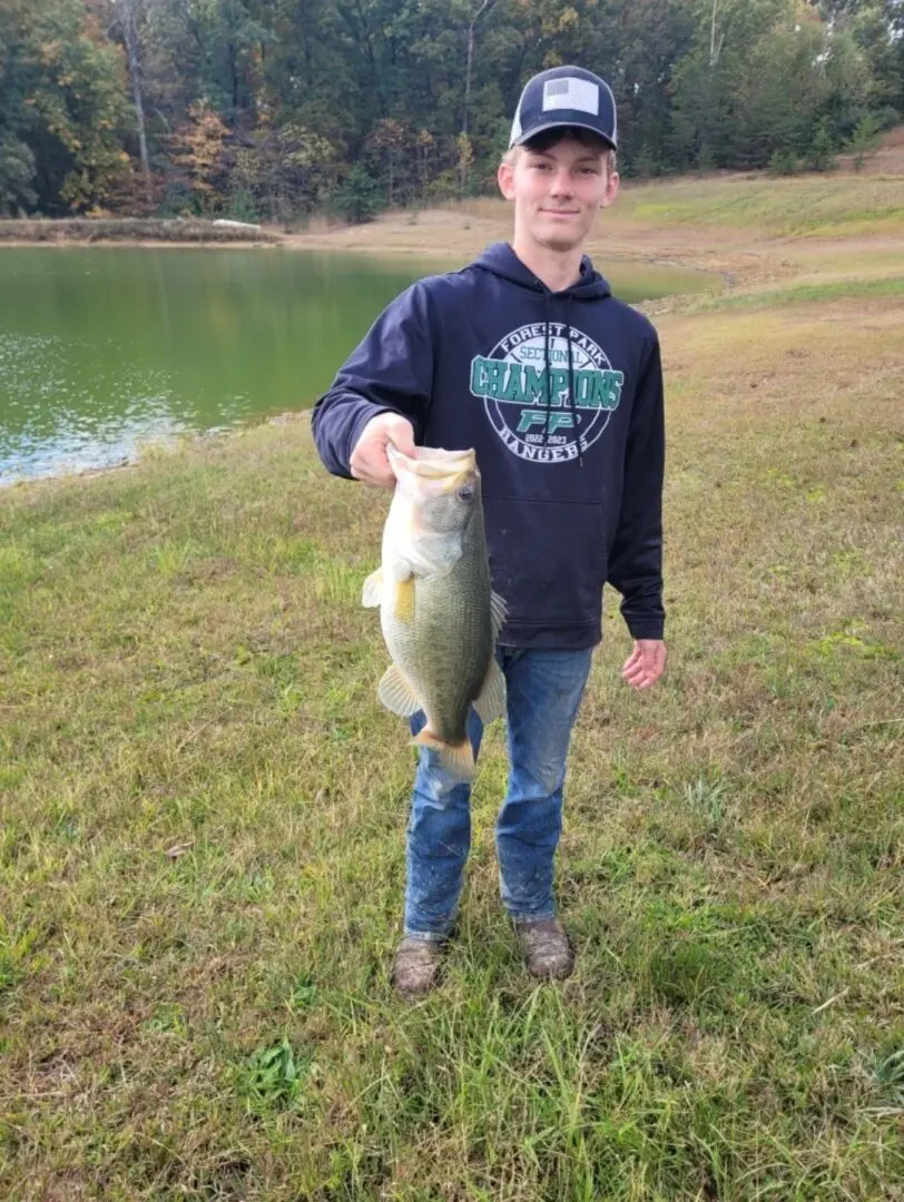 A man holding a large fish in his hand.