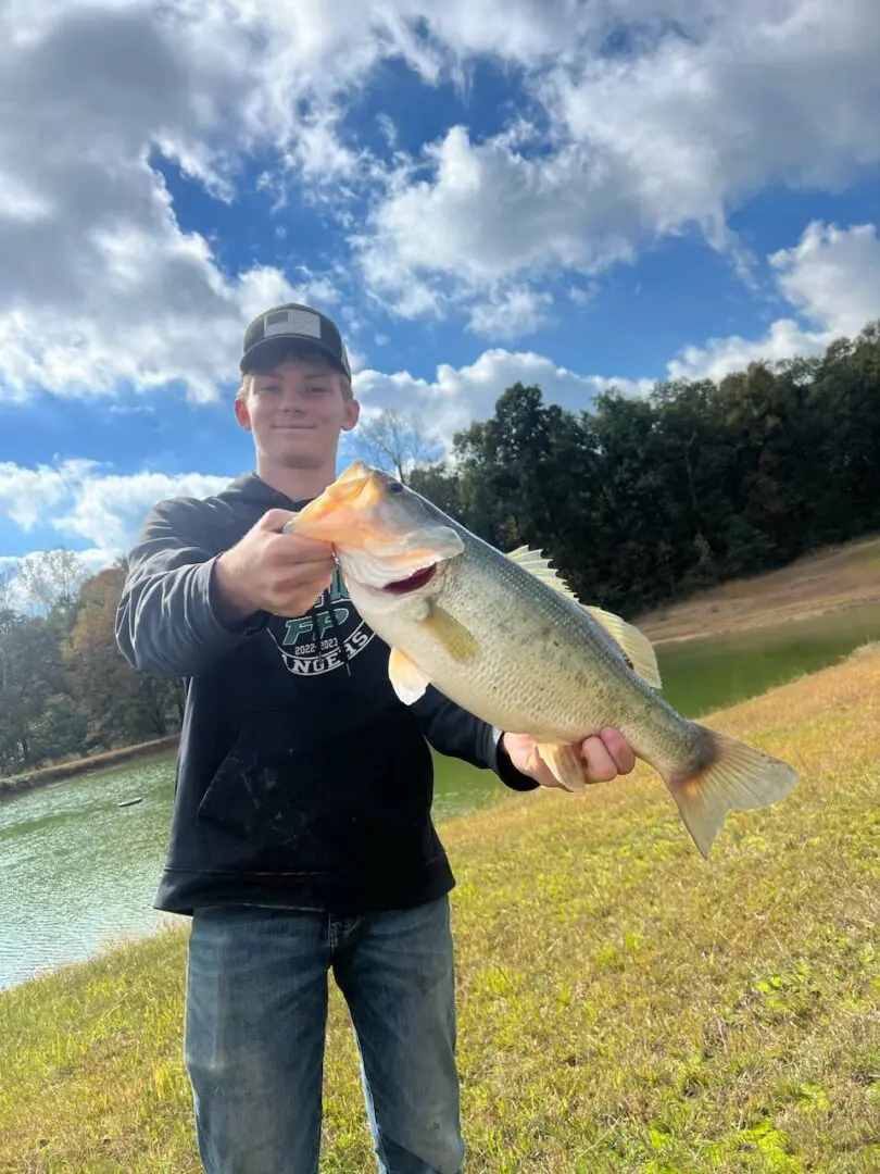 A man holding a large fish in his hand.